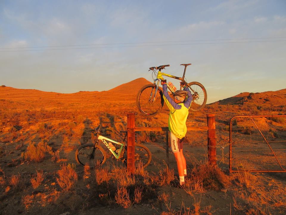 Ride The Karoo 100 Miler | Sneeuberg Nature Reserve | Luxury Karoo Farm Stay | Mountain Biker at Fence